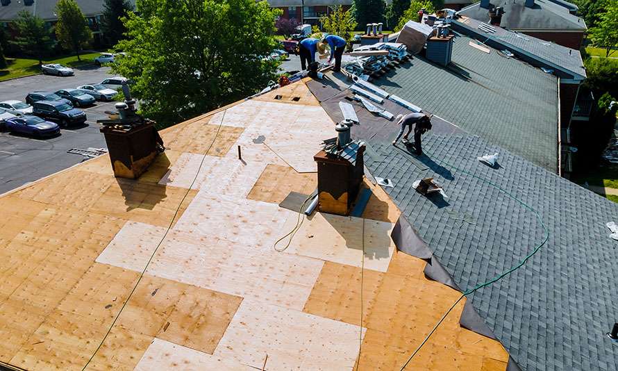 Roofing Team Replacing Roof Shingles