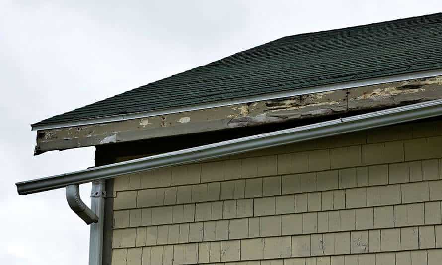 Broken Gutters On The Side of a House